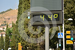 Very hot street thermometer at 44 degrees Celsius photo