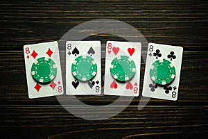 A very interesting and gambling game of poker with a successful winning combination of four of a kind or quads. Playing cards and photo