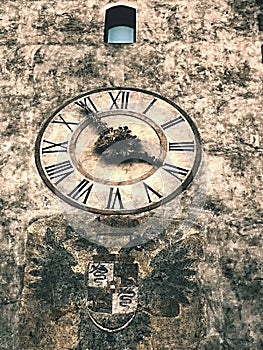 Very interesting historical clock on the old church in Bergamo, Italy