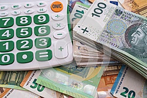 very large amounts of euro banknotes and zlotys and a calculator with a beautiful keyboard.
