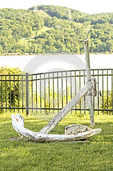 Very large anchor to a ship on grass in park