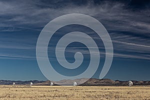 Very Large Array line of radio astronomy observatory telescopes in the New Mexico desert, copy space in blue sky photo