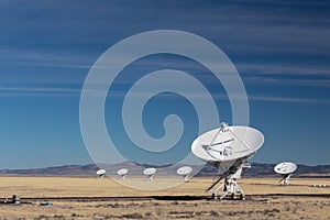 Very Large Array of radio astronomy observatory dishes in winter, science and technology