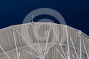 Very Large Array structure under a large radio telescope antenna dish at the VLA in New Mexico photo