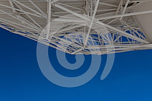 Very Large Array understructure of a large radio telescope dish with blue sky below, creative copy space, science technology