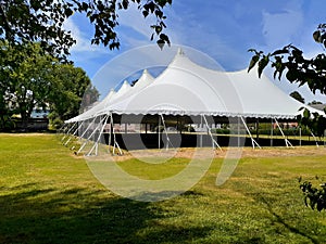 A very large majestic white party or wedding reception tent