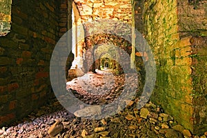 Very long corridor with many arches. Abandoned Tarakaniv Fort in the summer day. Tarakaniv, Rivne oblast, Ukraine photo