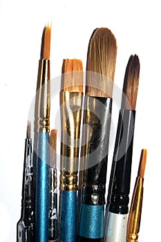Messy Used Paint Brushes on White background
