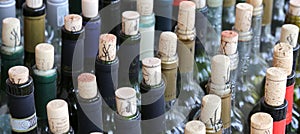 Very much stacked up wine bottles with corks