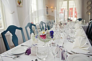 A very nicely decorated wedding table with plates and serviettes.