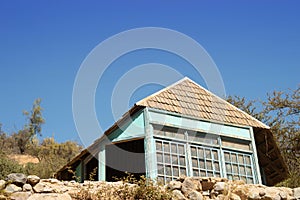 a very old blue house against a blue sky