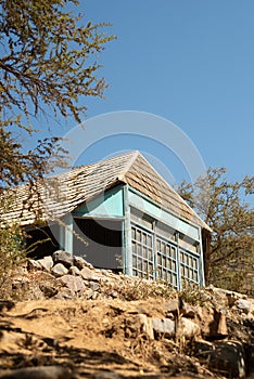 a very old blue house against a blue sky