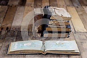 Very old book and key on an old wooden table. Old room, wooden t