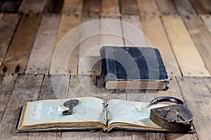 Very old book and key on an old wooden table. Old room, wooden t