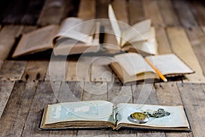 Very old book and key on an old wooden table. Old room, wooden t