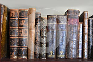 Very old books with leather cover on a shelf