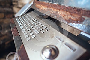 Very old computer, rusty keyboard with monitor