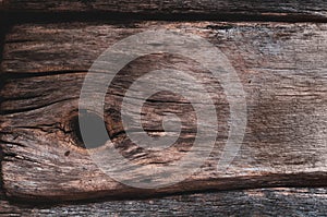 Very old cracked boards, wood that has darkened from time and weathering, close-up. Grunge background wood texture
