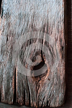 Very old cracked boards, wood that has darkened from time and weathering, close-up. Grunge background wood texture