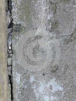 Very old cracked grey wall made of concrete or cement. Brickwork. Plaster.