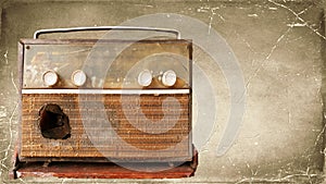 A very old, damaged radio player with an old picture background