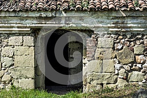 Very old entrance door and stone wall on antique building