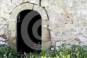 Very old entrance stone door and wall in forest