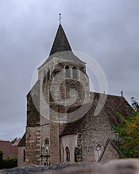 A very old French church in a grey and cloudy day