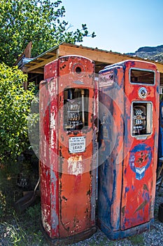 Very old gasoline pumps beside a 2 lane road in the middle of nowhere