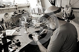 A very old jewelery shop and a jeweler in work