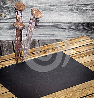 very old large nails on a beautiful wooden background, rusty