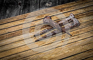 very old large nails on a beautiful wooden background, rusty