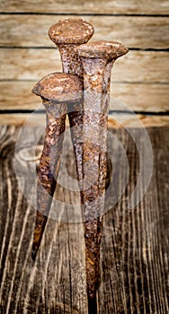 very old large nails on a beautiful wooden background, rusty