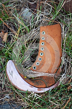 Very old leather boot lying on the ground
