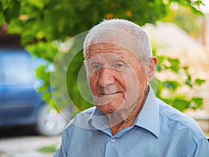 Very old man portrait. Grandfather relaxing outdoor at summer. Portrait: aged, elderly, senior. Close-up of old man