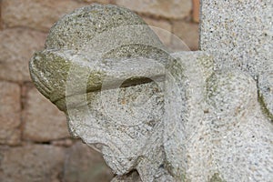 Very old pilgrim figure head sculpted on a column of a building in Tui in Portugal. photo