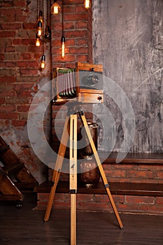 A very old rarity photo camera stands on a tripod in the Studio. nobody