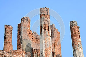 Very old red brick pole, old temple, on blue sky background