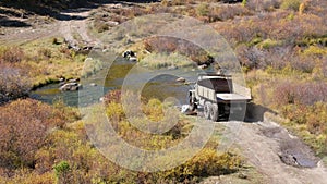 Very old russian truck crossing river Kurkurek on Altai mountain plateau Eshtykel