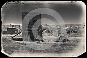 Very old sepia vintage photo with abandoned western building in the middle of a desert