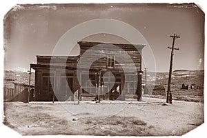 Very old sepia vintage photo with abandoned western saloon building in the middle of a desert