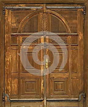 Very old solid wooden door in retro 19th century design close up