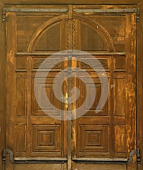 Very old solid wooden door in retro 19th century design close up