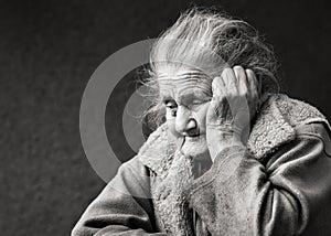 Very old and tired wrinkled woman outdoors