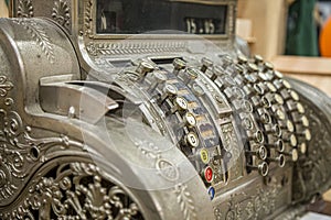 Very old vintage style cash register close-up.