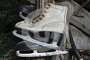 Very Old White and Black Rusty and Dirty Ice Skates Hanging in Warehouse