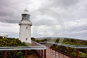 Very old white lighthouse at Cape Naturaliste, Western Australia in overcast weather