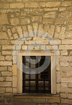 Very old window in brick stone wall of castle or fortress of 18th century. Full frame wall with window