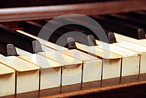 Very old wooden piano with ivory keys broken