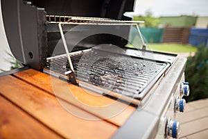 Very polluted modern grill after summer grilling, BBQ concept